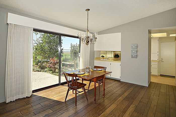 Cheery dining area with wood floors and beautiful views