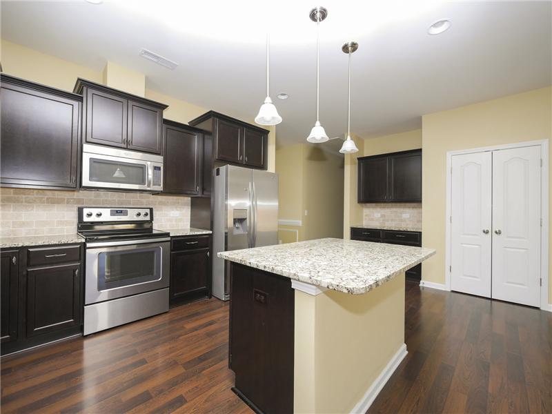 Abundant cabinetry plus pantry in kitchen