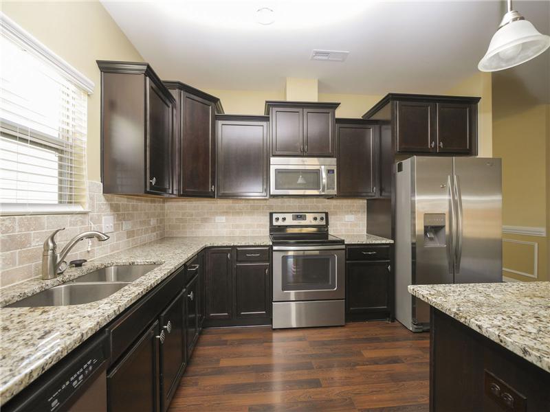 Extensive granite countertops and tile backsplash