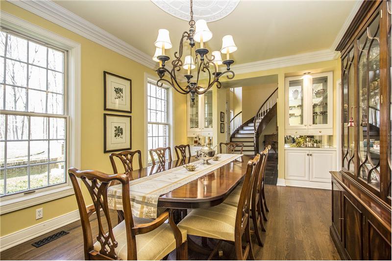 Formal Dining Room (17’4 x 11’5) features hardwood flooring, and custom built-in buffets with display cabinets