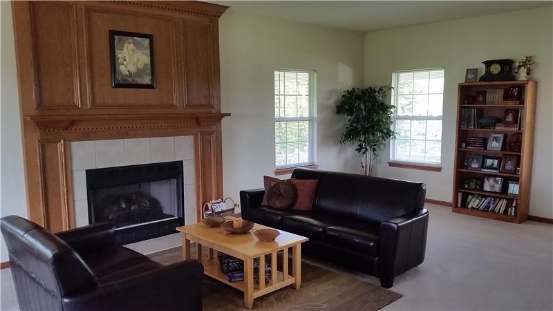 And to the right you'll find a large Family Room that runs the entire width of the home with a woodburning Fireplace.