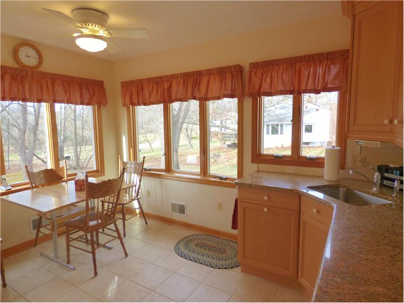 Updated kitchen with granite counters and beautiful views of back yard.