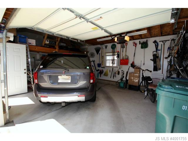 Garage with storage loft & pegboard wall
