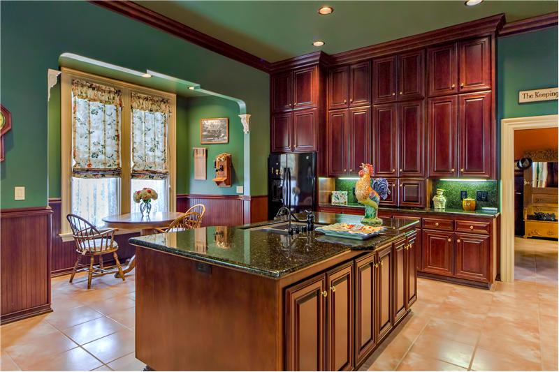 Gourmet Kitchen featuring Floor to Ceiling Custom Cherry Wood Cabinetry