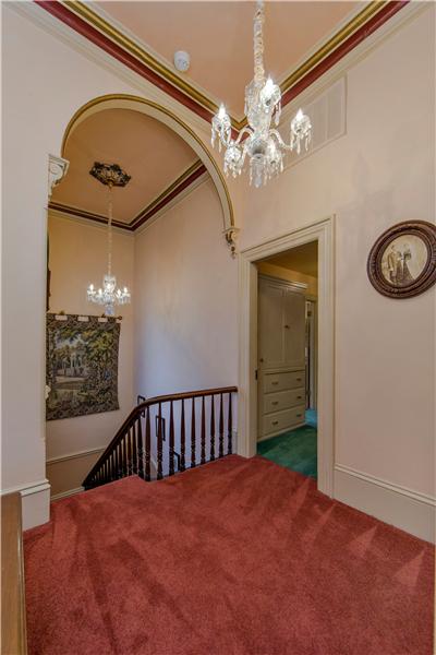 Matching Two Tiered Waterford Crystal Chandeliers Grace the Stairwell & Upstairs Landing