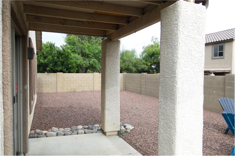 Covered patio with large yard