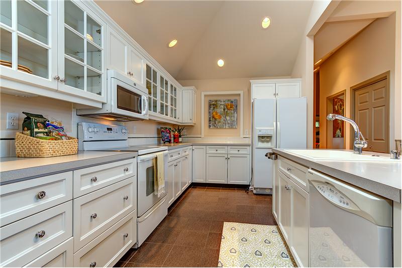 Built-in Breakfast Nook, Center Island, Custom White Cabinets and Tile Floors.