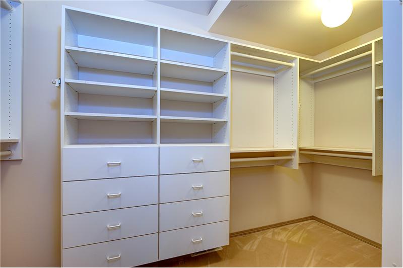 Large Master Bedroom closet with Custom Built-Ins and Shelves.