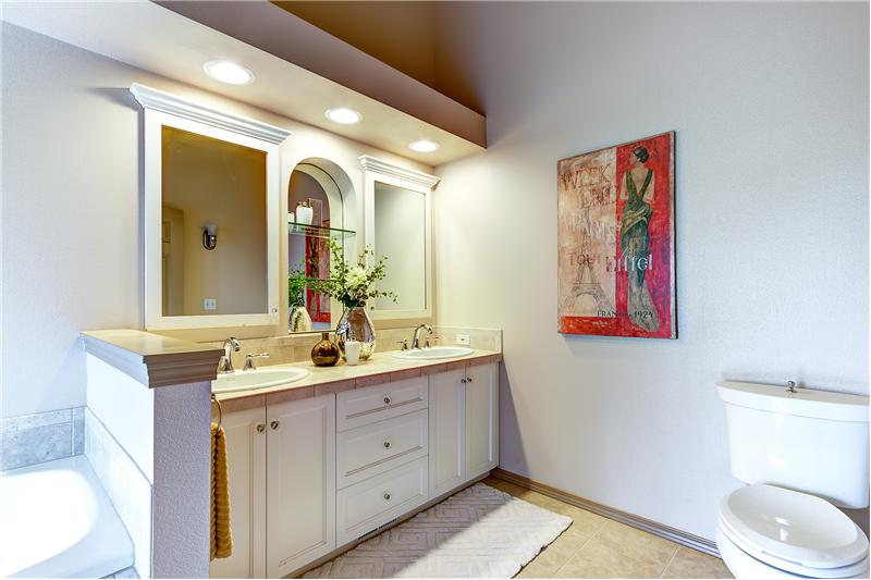 Private Master Bathroom with Dual Sinks, Tile Countertops,Tile Floors and Vaulted Ceilings.